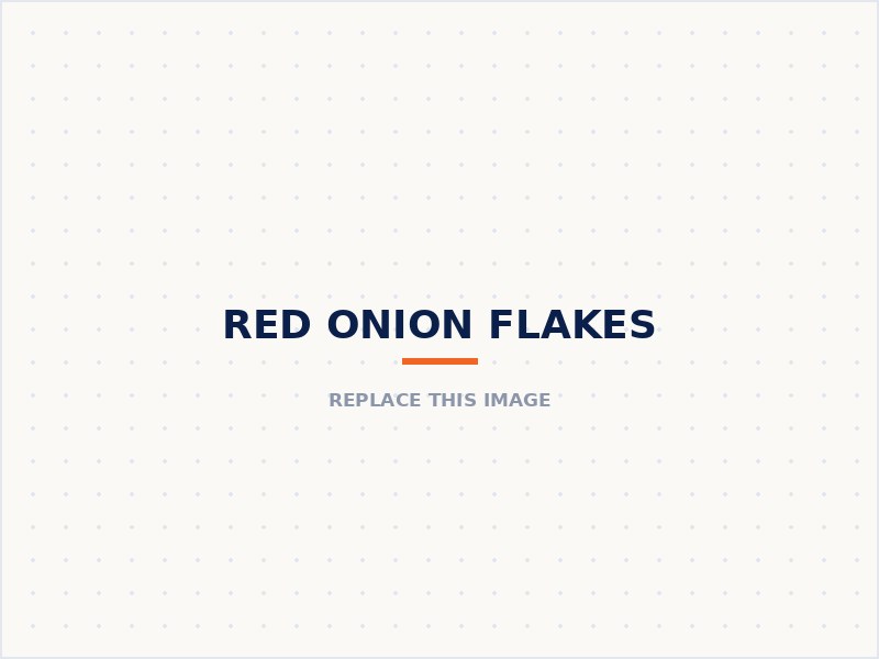 Red onion flakes in a wooden bowl beside whole red onions